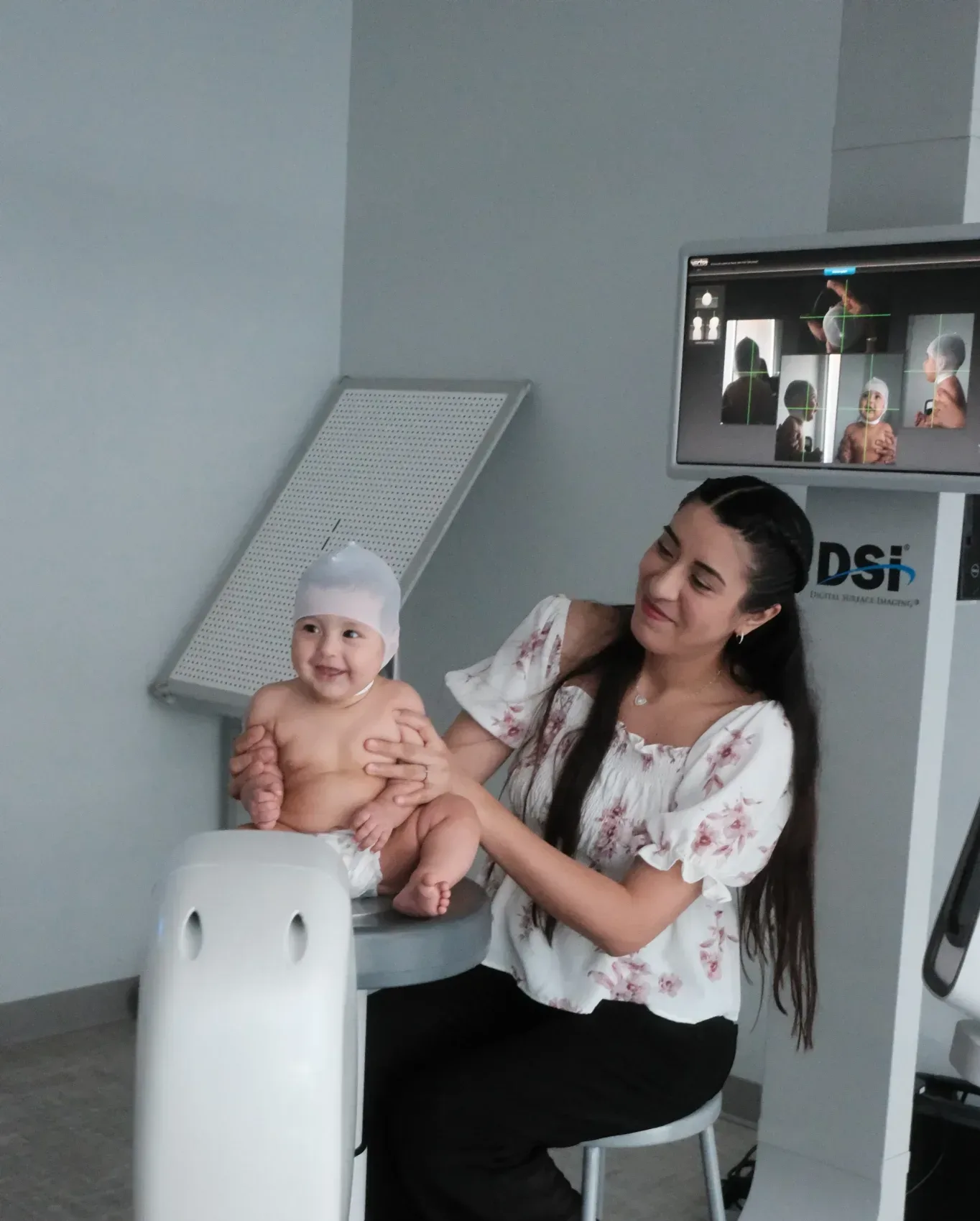 Specialist performing DSi scan on baby