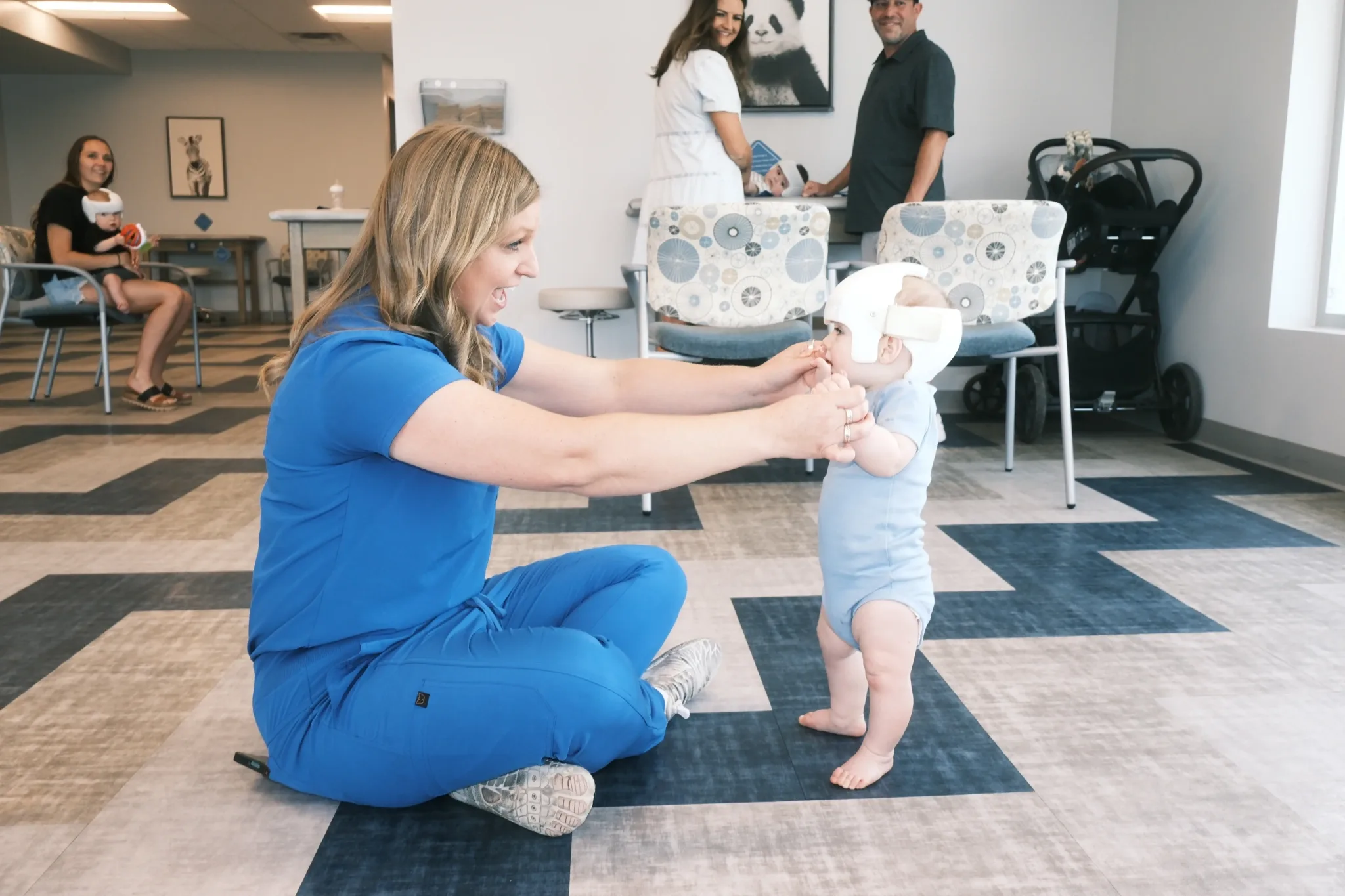 Clinician fitting DOC Band on baby