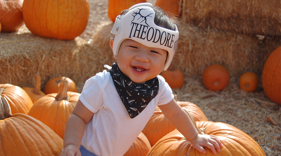 Theodore in a DOC Band smiling in a pumpkin patch