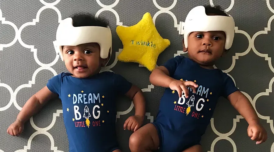 Twins in doc bands wearing t-shirts that say dream big!