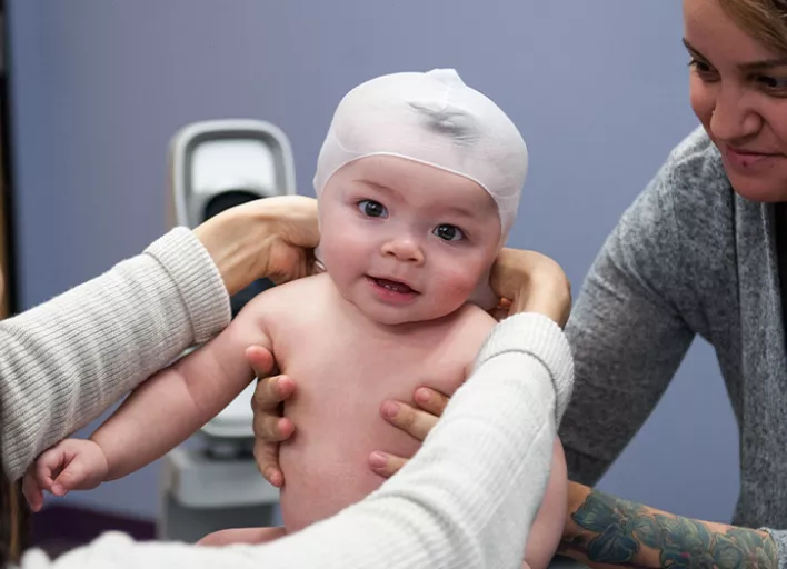 Cranial Technologies - Check out this DOC Band Baby in the arms of