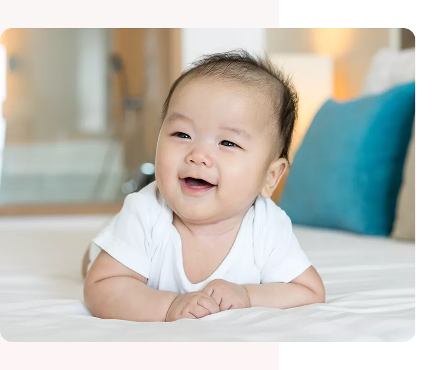 Baby smiling while lying on his stomach